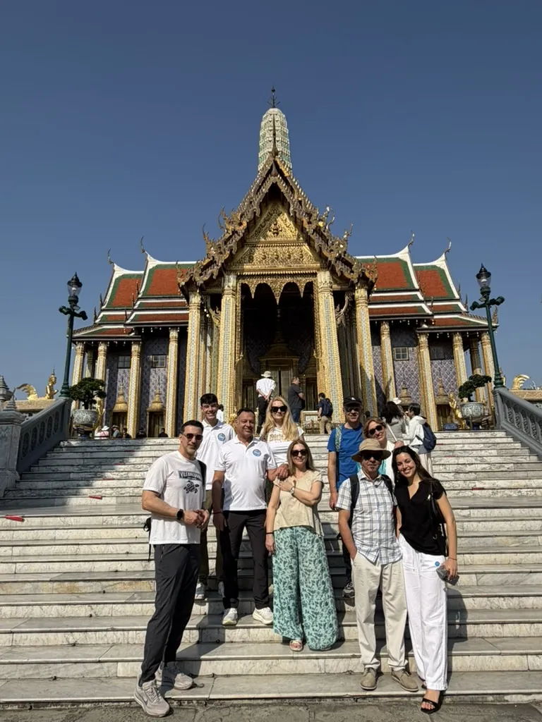Folkpaths guests gathered on the steps of a temple at the Grand Palace